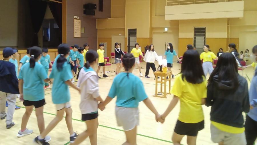 輪になって踊る子どもたちの写真